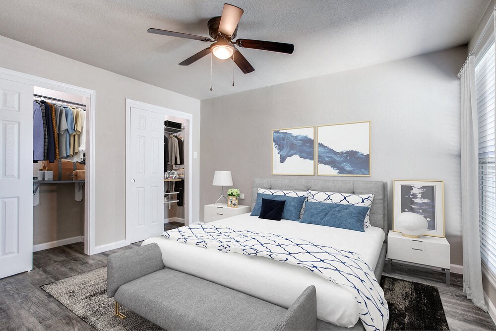a bedroom with a large bed and a ceiling fan