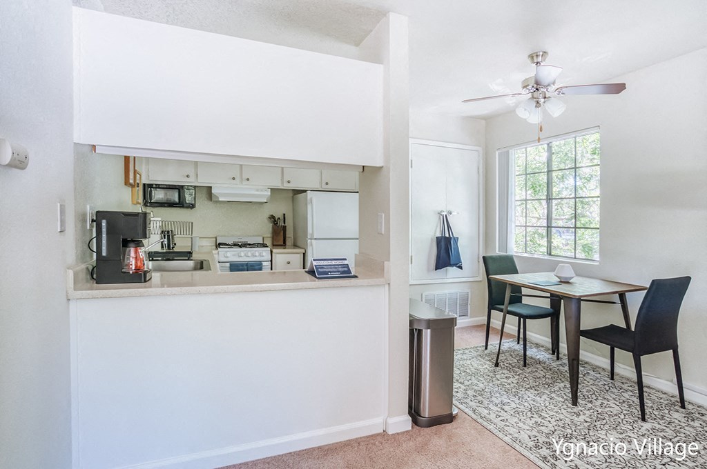 a kitchen and dining room with a table and chairs