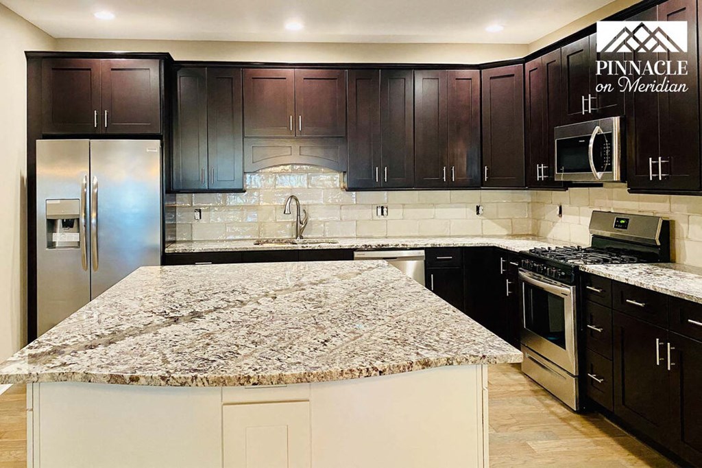 a kitchen with a large island in the middle of it