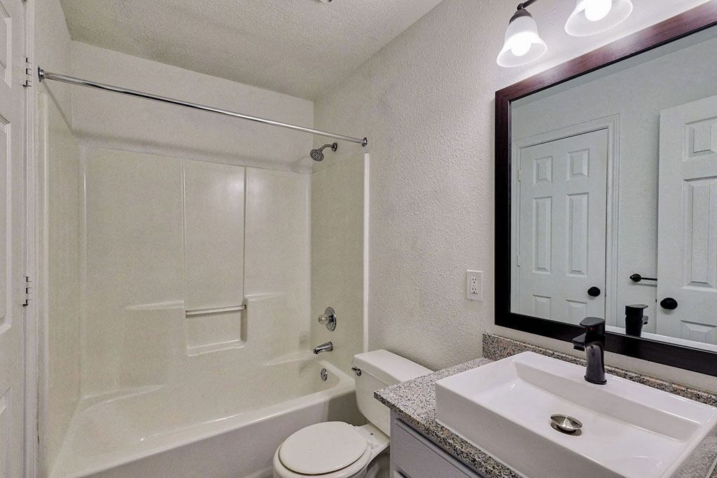 a bathroom with a sink toilet and bathtub