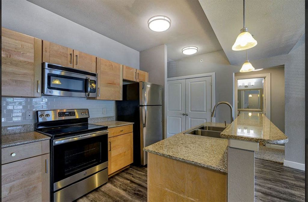 a kitchen with a stove top oven next to a sink