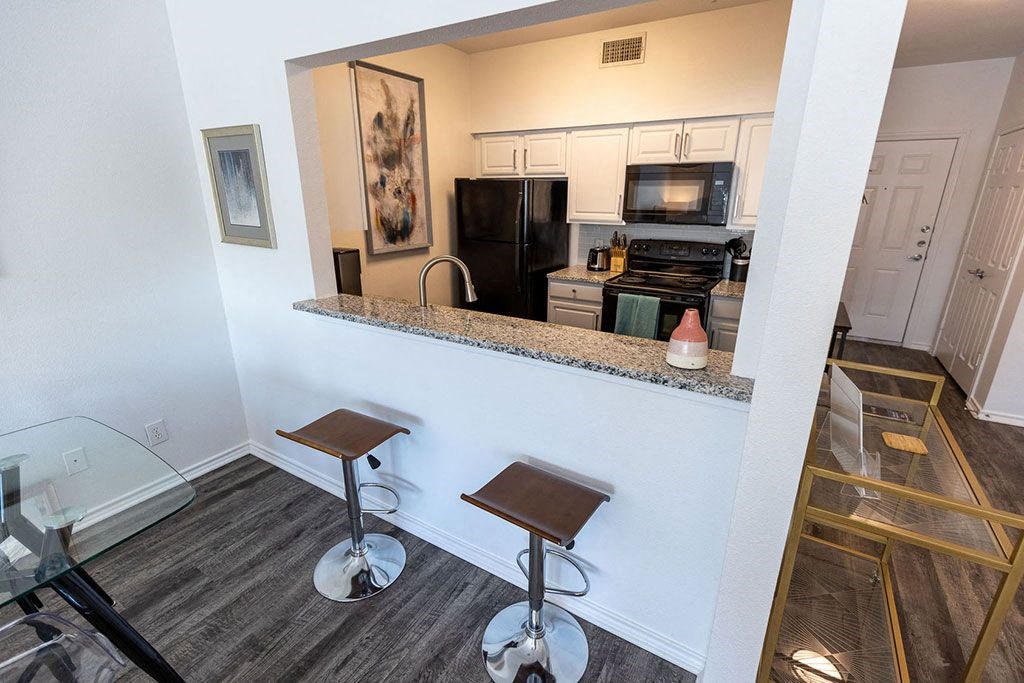 a view of the kitchen and living room from the balcony