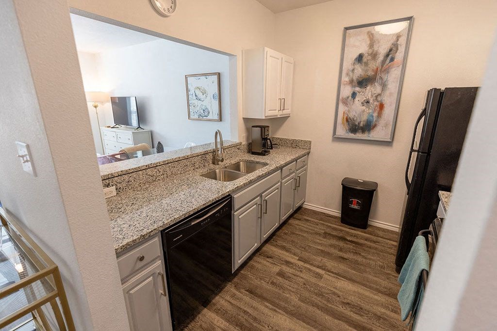 a kitchen with granite countertops and a sink