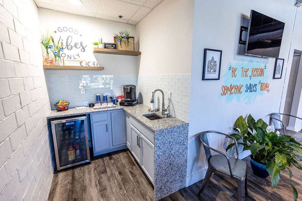 a small kitchen with a small table and chairs