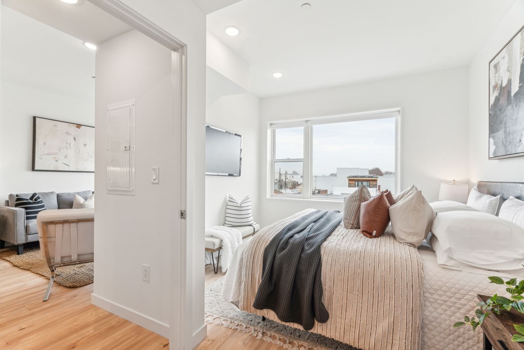 A bedroom with a large bed and a view of the outside.