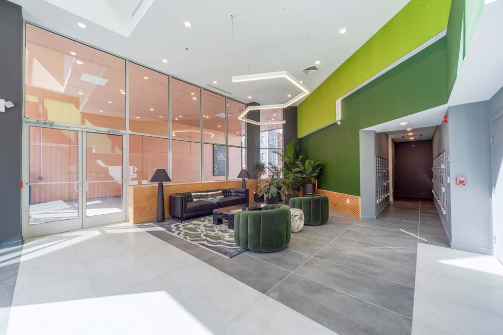 A modern interior with a glass wall and a green accent wall.