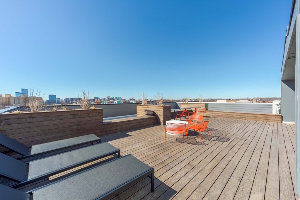 A wooden deck with two chairs and a table.