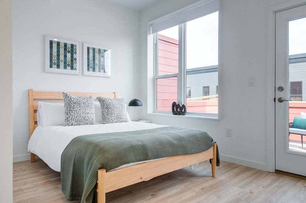 a bedroom with a bed and two windows