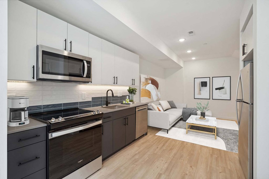 A modern kitchen with dark wood cabinets and stainless steel appliances.