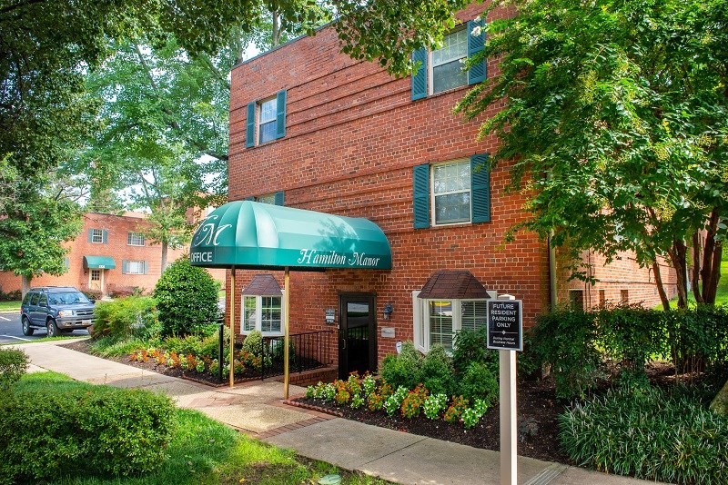our apartments are located in a brick building with a green awning
