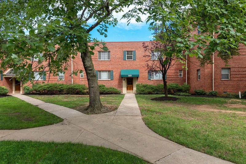 a walkway in front of a red brick building
