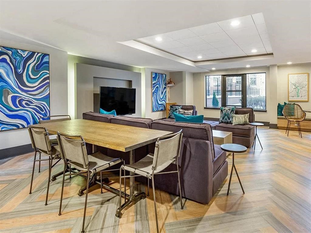 a living room with a table and chairs and a television