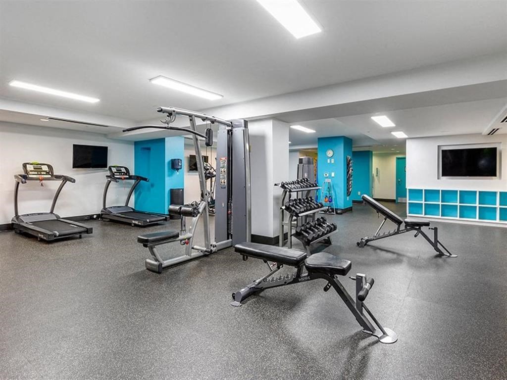 the gym in the basement of a building with exercise equipment