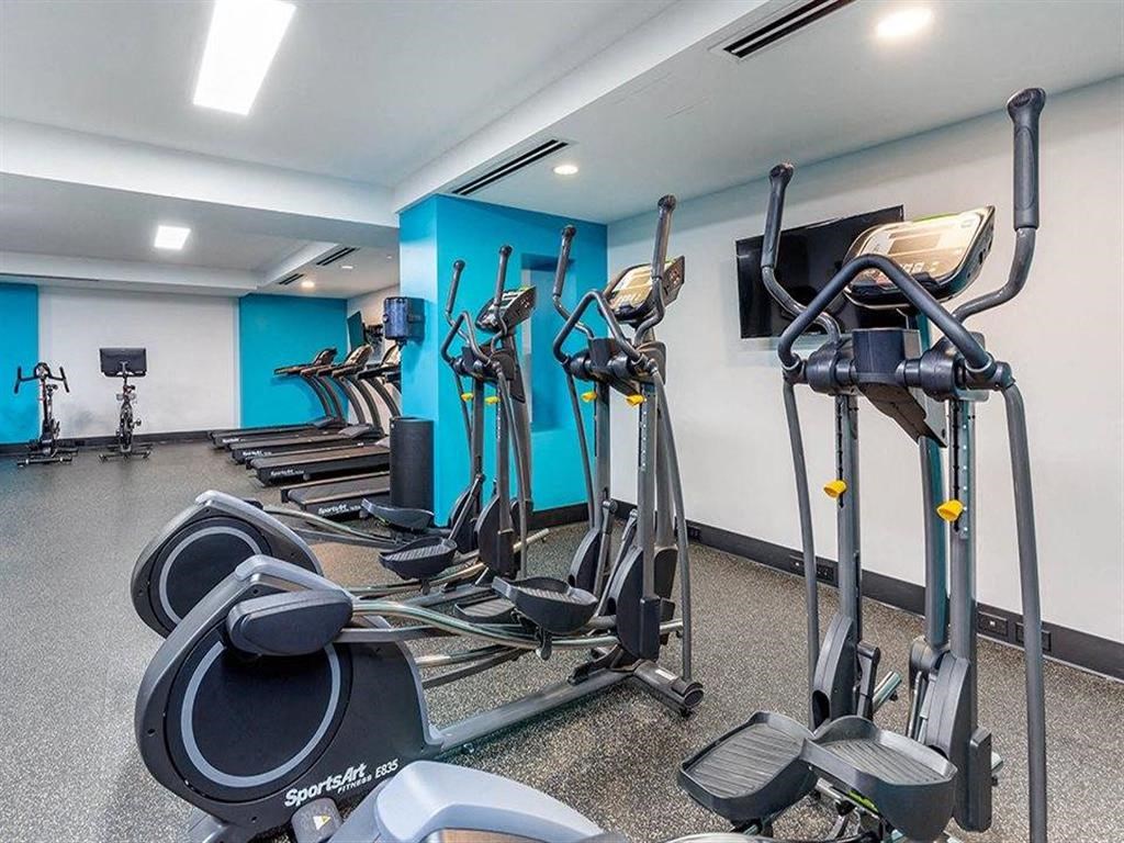 a gym with various exercise equipment in a room