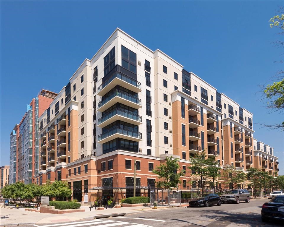 an apartment building on the corner of a city street