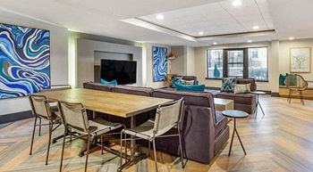 a large living room with a table and chairs