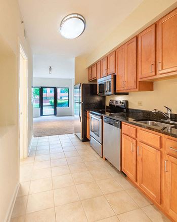 a kitchen with wooden cabinets and a sink and a refrigerator
