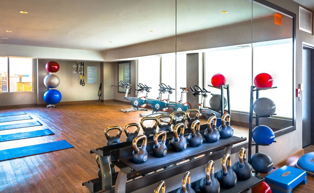 a gym with weights and a row of exercise machines