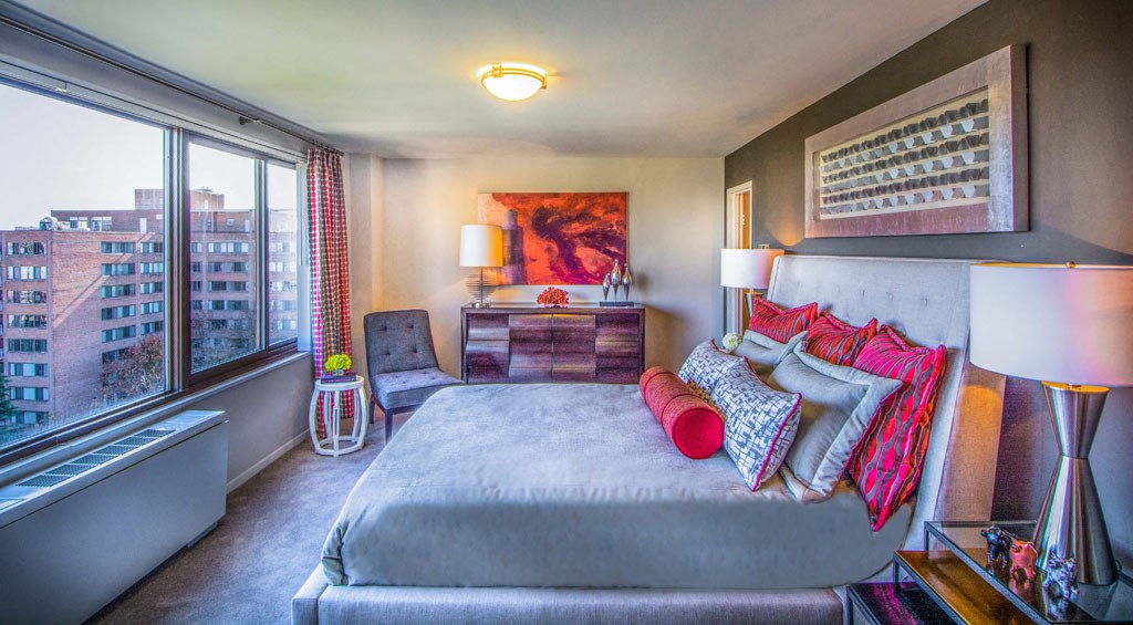 a bedroom with a bed and a large window