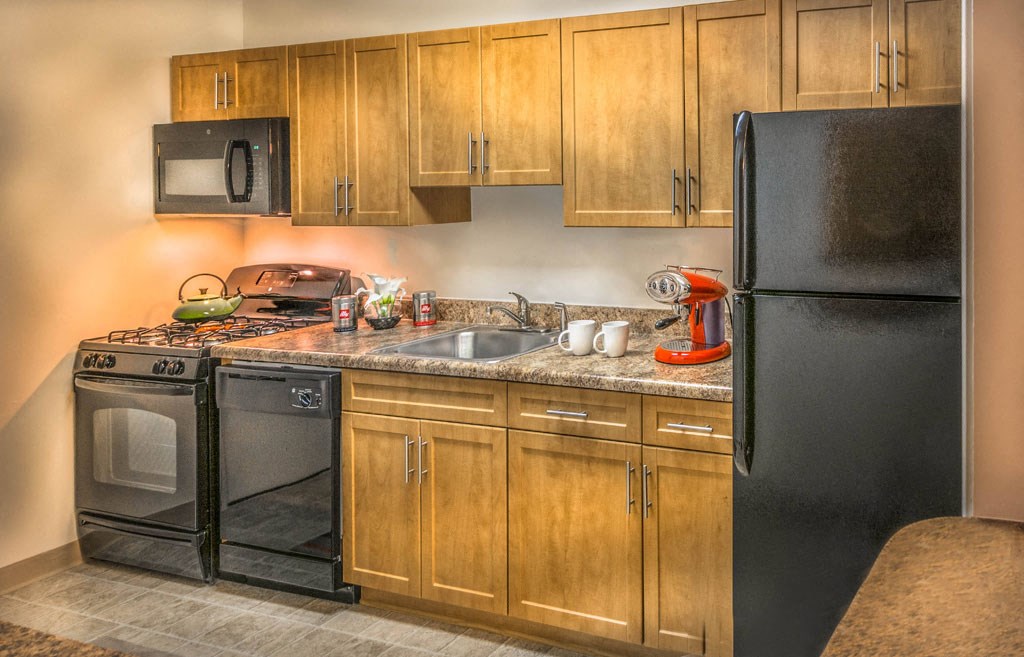 a kitchen with a stove refrigerator and sink