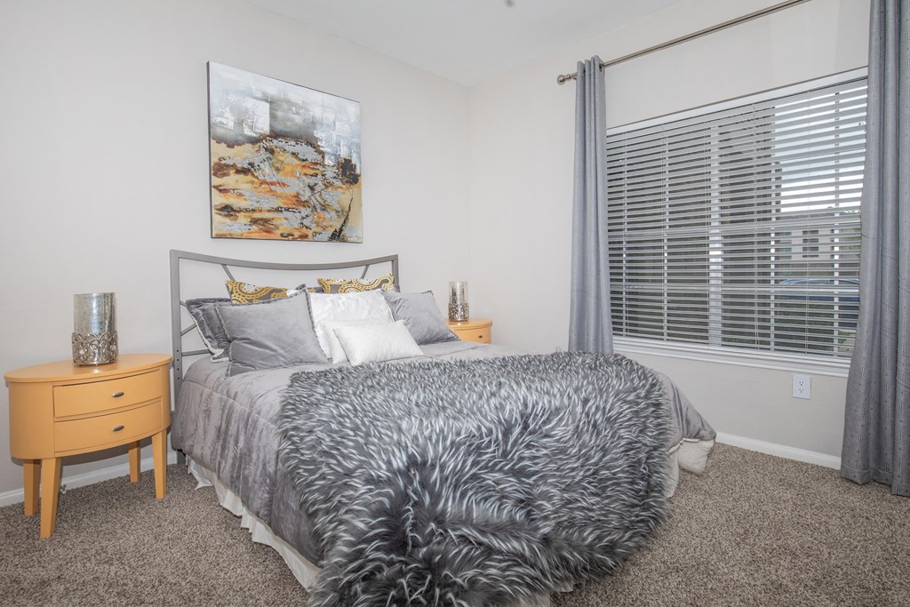 Affordable Houston Texas Apartments – Westchase Forest – Photo of a bedroom with a bed and a large window