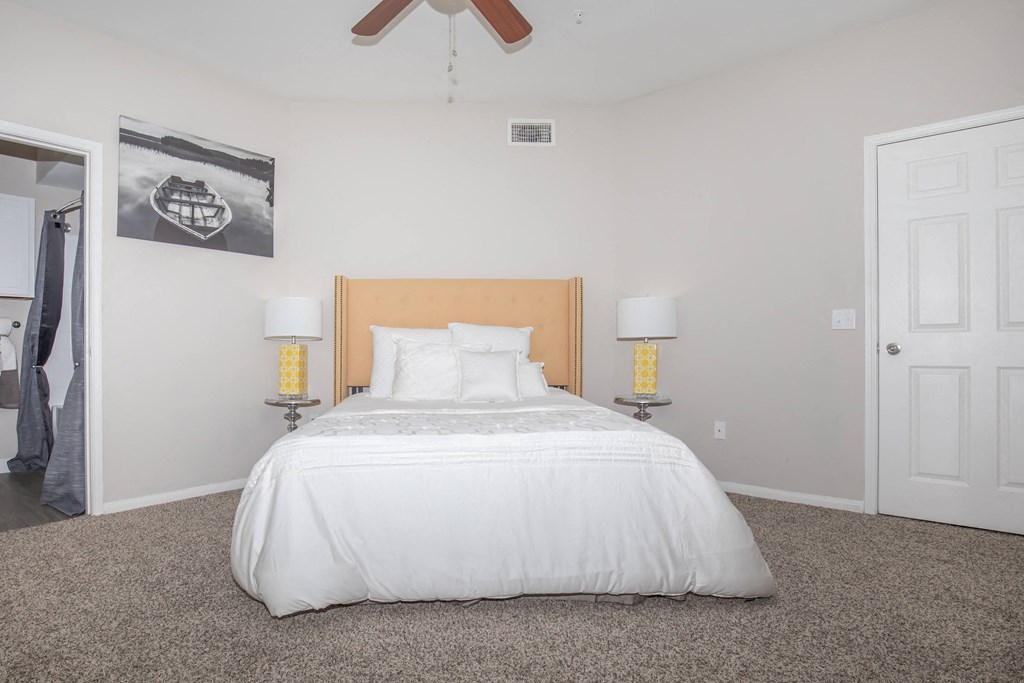 Apartments In Houston Texas for Rent – Westchase Forest - Photo of a bedroom with a white bed and a ceiling fan