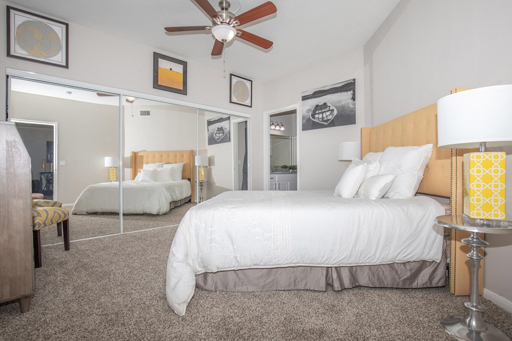 Affordable Houston Texas Apartments – Westchase Forest – Photo of a bedroom with a large bed and a ceiling fan