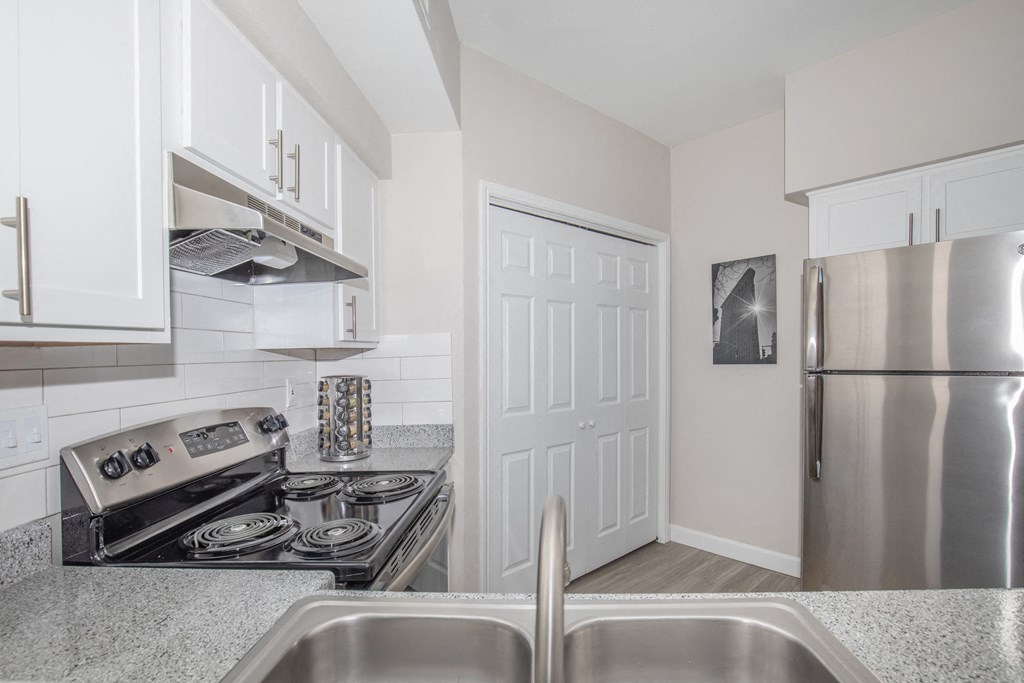 Affordable Houston Texas Apartments – Westchase Forest – Photo of a kitchen with stainless steel appliances and granite counter tops
