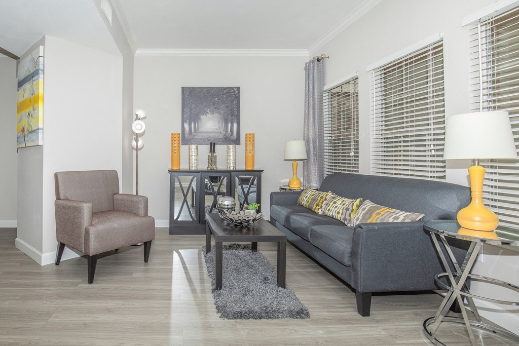 Apartments In Houston Texas for Rent – Westchase Forest - Photo of a living room with a gray couch and a coffee table