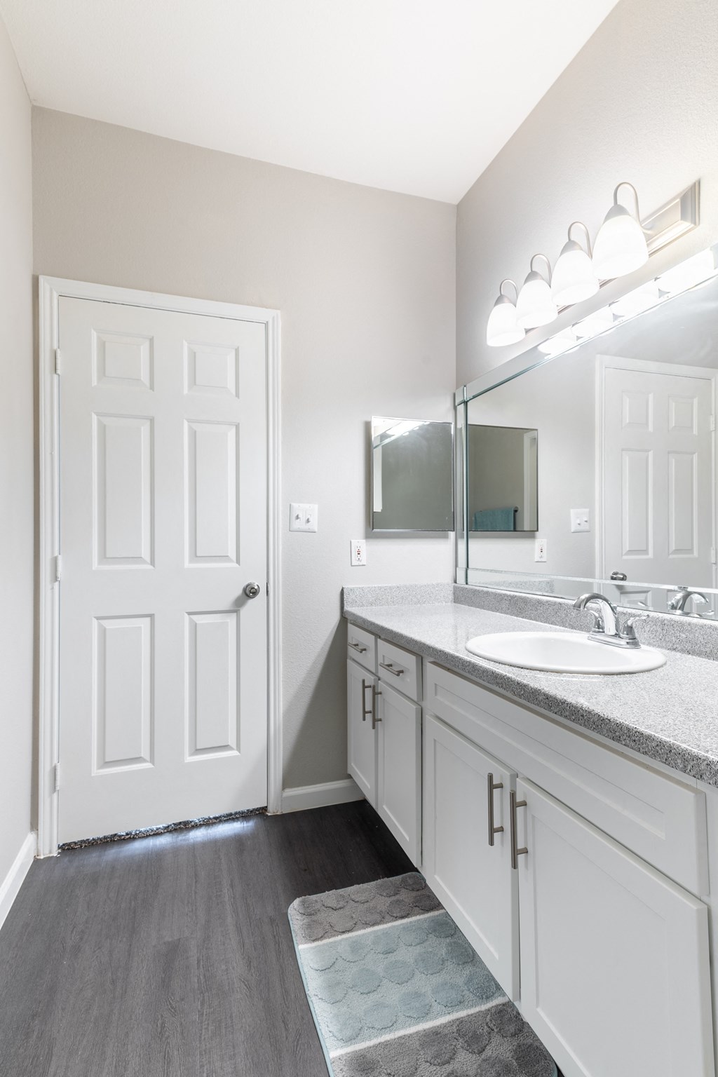 an empty bathroom with a sink and a mirror