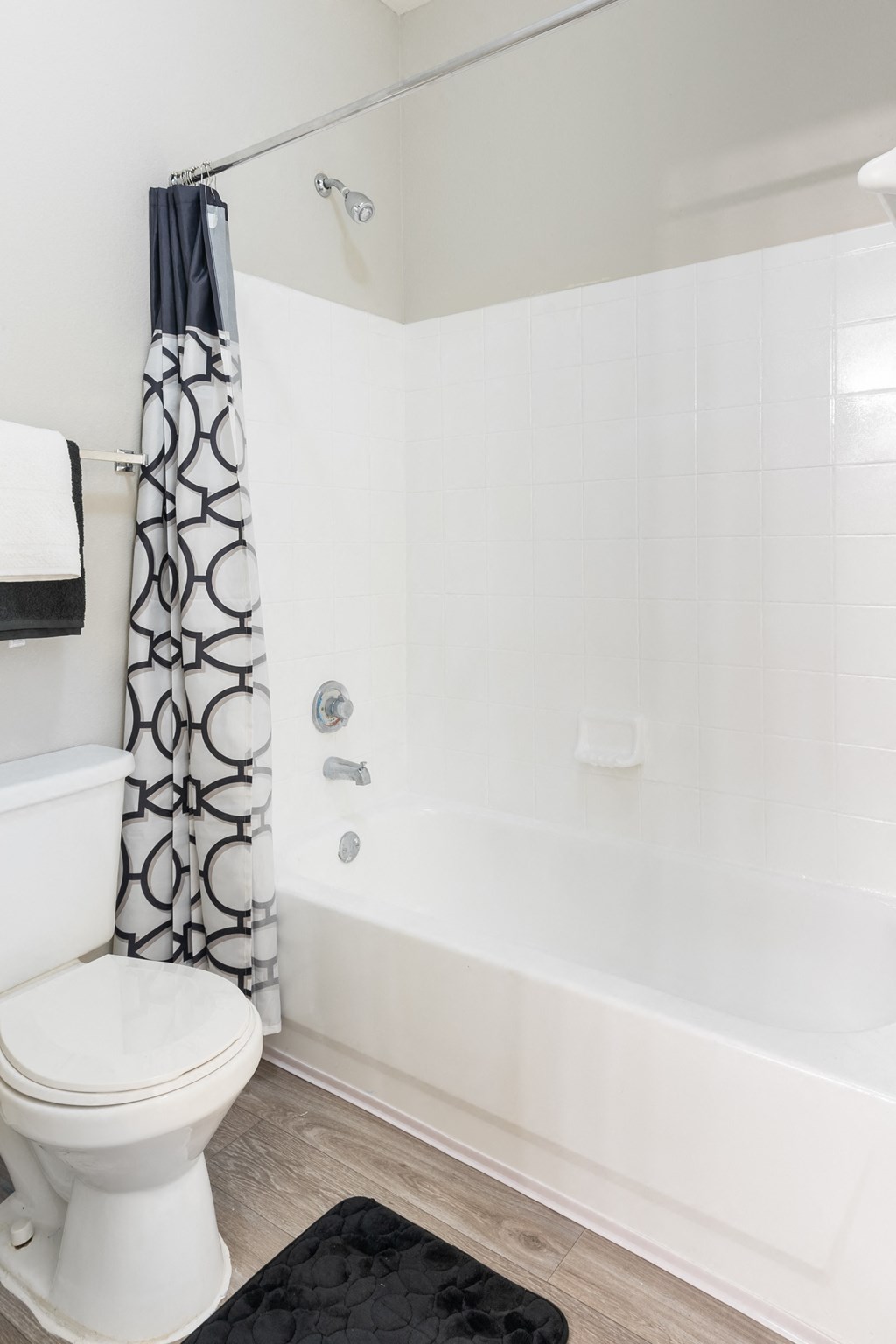 Affordable Houston Texas Apartments – Westchase Forest – Photo of a bathroom with a white toilet and a tub and a shower curtain