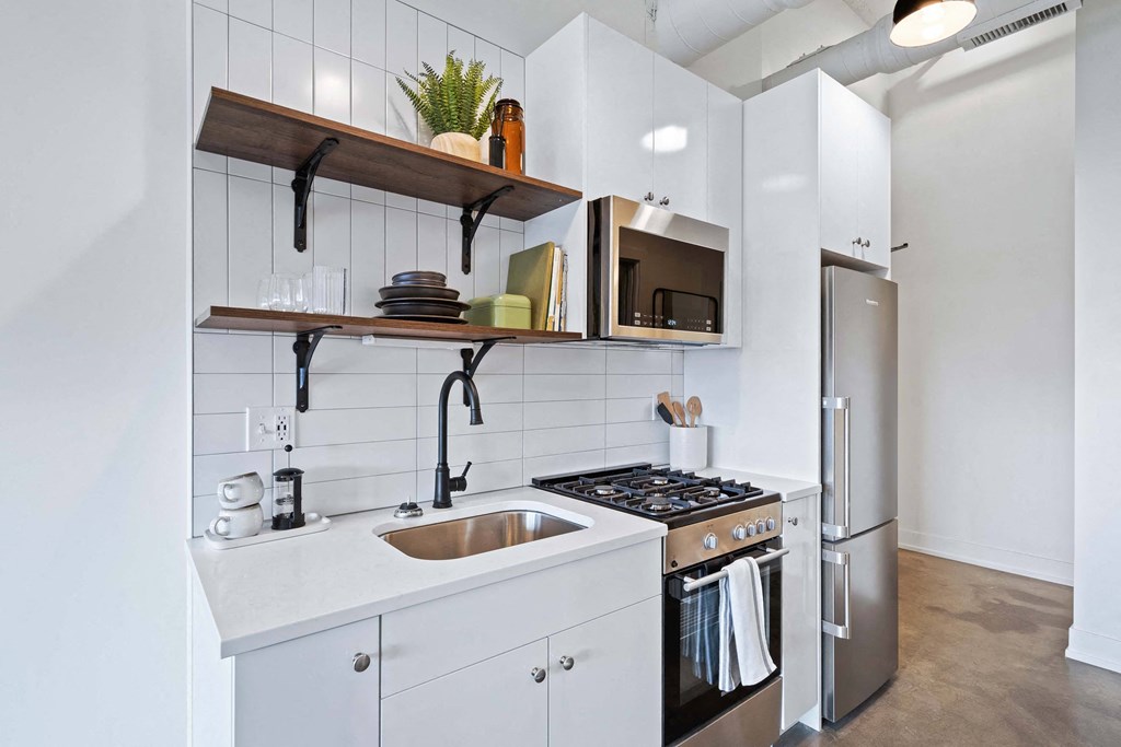 a kitchen with a sink and a stove and a refrigerator