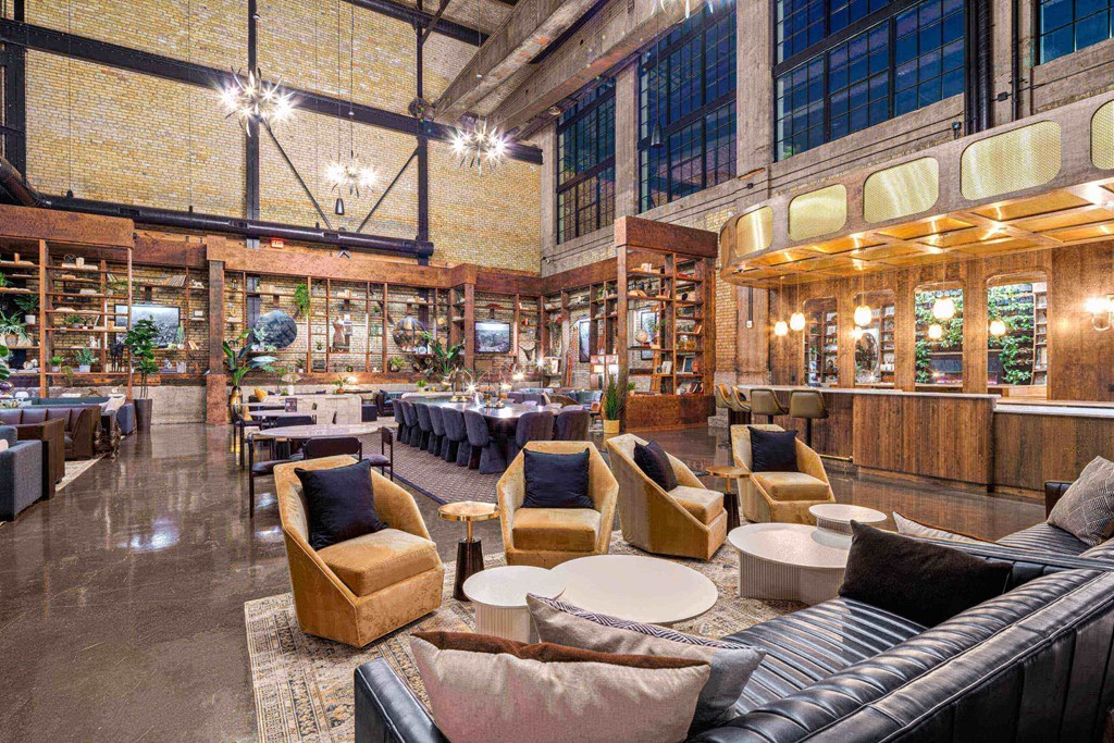 a large room with couches and chairs and tables