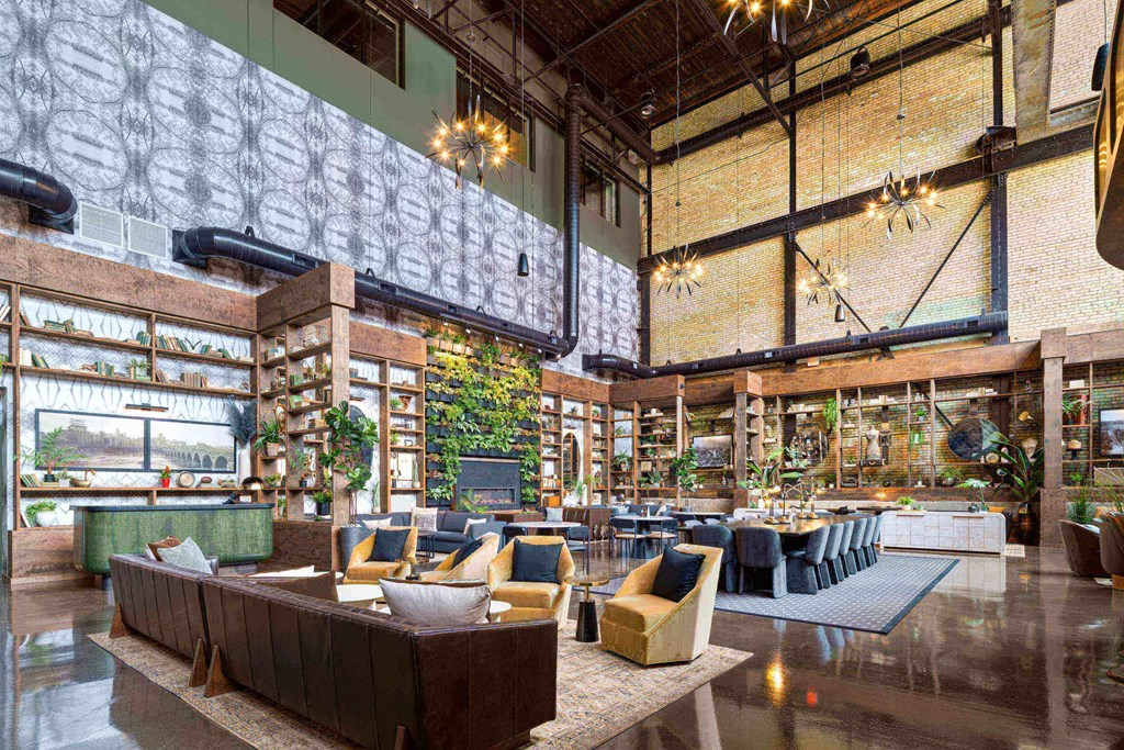 a rendering of the lobby of a building with furniture and tables