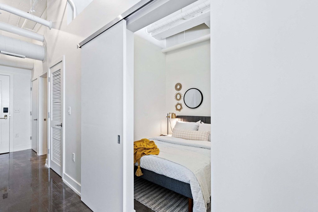 a bedroom with a bed and a sliding glass door