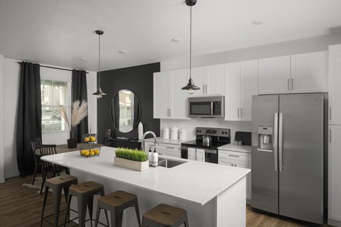a kitchen with stainless steel appliances and a white counter top