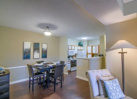 Open dining area with wood-style flooring in classic apartment home at Enclave at Wolfchase near Memphis, TN.