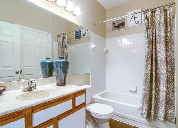 Classic bathroom with large vanity and shower/tub combo at Enclave at Wolfchase Apartments in Cordova, TN.