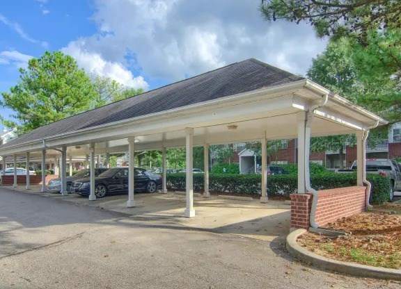 A covered parking area with cars parked in it.
