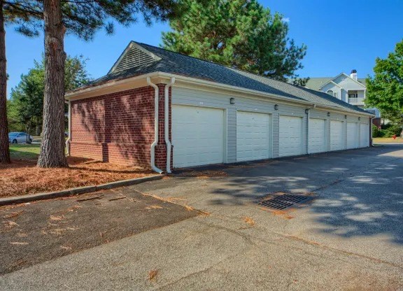 A two-car garage with a brick facade and white garage doors.