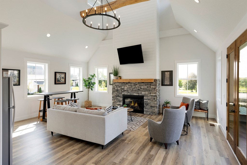 A modern living room with a fireplace and a large couch.