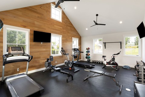 A spacious home gym with a variety of exercise equipment.