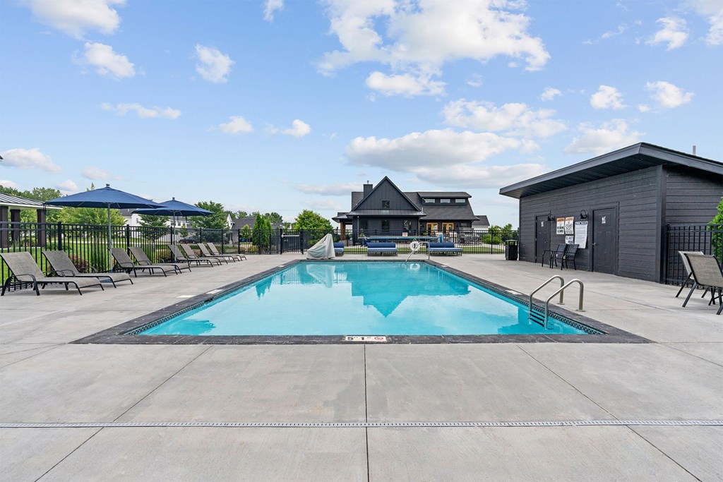 A large swimming pool with a building in the background.