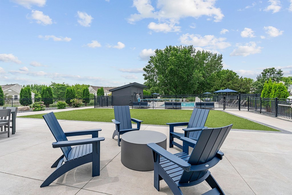A park with blue chairs and tables.