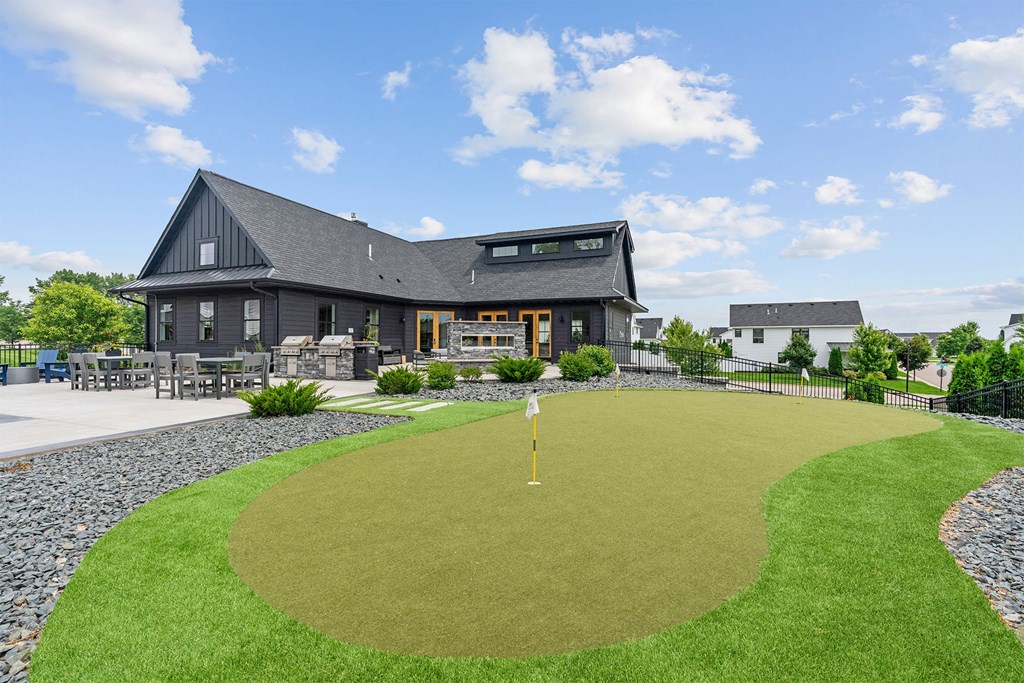 A golf course with a green and a yellow flag.