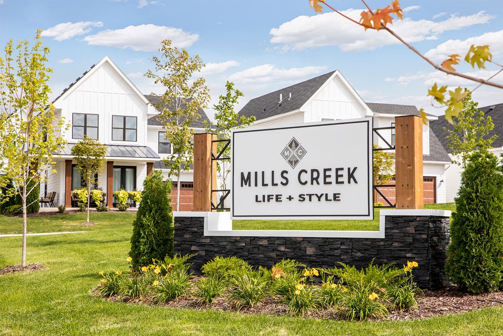 Mills Creek Life + Style sign in front of a house.