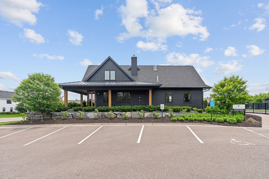 A large building with a parking lot in front.
