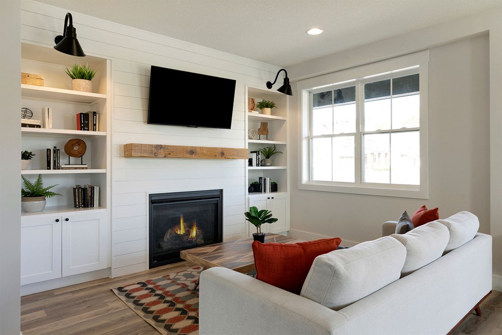 A living room with a fireplace and a white couch.