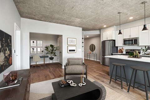 A modern living room with a grey armchair and a coffee table in the center.