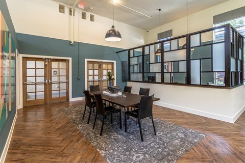 A dining room with a wooden table and chairs.